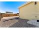 A sunny backyard features rock, a fence, and the side of the home at 47385 Lily Ave, Bennett, CO 80102