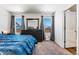This bedroom features carpet floors, large windows, and black furniture at 47385 Lily Ave, Bennett, CO 80102