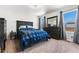 This bedroom features carpet floors, large windows, and a dresser with a mirror at 47385 Lily Ave, Bennett, CO 80102