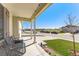 Relaxing front porch with comfortable seating and views of the neighborhood street at 47385 Lily Ave, Bennett, CO 80102