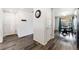 Open hallway featuring hardwood floors and access to the dining area at 47385 Lily Ave, Bennett, CO 80102