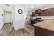 Modern kitchen equipped with stainless steel appliances and dark cabinets at 47385 Lily Ave, Bennett, CO 80102