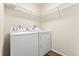 This laundry room features a washer, dryer, and wire shelving at 47385 Lily Ave, Bennett, CO 80102