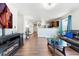 Open-concept living area with wood floors, plenty of natural light, and modern decor at 47385 Lily Ave, Bennett, CO 80102