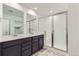 Bright primary bathroom with double vanity, and walk-in shower with glass door at 6751 Arbor E Blvd, Thornton, CO 80602
