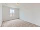 Bedroom featuring neutral carpet, white walls, and a window that lets in natural light at 6751 Arbor E Blvd, Thornton, CO 80602