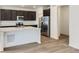 Modern kitchen with stainless steel appliances, a center island with quartz countertops, and hardwood floors at 6751 Arbor E Blvd, Thornton, CO 80602