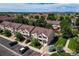 Aerial view showcasing community townhomes, green spaces, parking, with mountain views in the background at 12783 Ivy St, Thornton, CO 80602