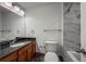 Bathroom featuring a granite sink counter, light-up vanity mirror, and tiled shower and tub at 12783 Ivy St, Thornton, CO 80602