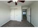 Bedroom featuring carpet, a ceiling fan, and closet with bi-fold doors at 12783 Ivy St, Thornton, CO 80602