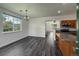 Bright dining room featuring modern lighting and newer floors, flowing into a kitchen with stainless steel appliances at 12783 Ivy St, Thornton, CO 80602