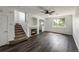 Inviting living area featuring a gas fireplace, wood floors, and stair access at 12783 Ivy St, Thornton, CO 80602