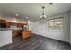 Open living space featuring wood floors, a kitchen island, and recessed lighting at 12783 Ivy St, Thornton, CO 80602