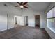 Spacious main bedroom with neutral carpet, ceiling fan, and ensuite bathroom at 12783 Ivy St, Thornton, CO 80602