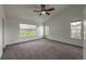 Spacious main bedroom with neutral carpet, ceiling fan, and natural light at 12783 Ivy St, Thornton, CO 80602