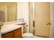 Functional bathroom featuring a shower stall with glass doors, sink, vanity, and toilet with neutral color palette at 10534 Ursula St, Commerce City, CO 80022