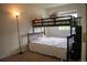 bedroom with bunk bed and stairs to top bunk and window giving natural light at 10534 Ursula St, Commerce City, CO 80022