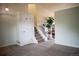 Bright entryway with carpet, coat closet, staircase, and view into the dining area at 10534 Ursula St, Commerce City, CO 80022