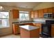 Functional kitchen featuring wood cabinets, stainless steel appliances, and an island at 10534 Ursula St, Commerce City, CO 80022