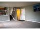 Spacious living room featuring neutral carpet, staircase and door to a hallway at 10534 Ursula St, Commerce City, CO 80022