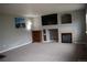 Cozy living room featuring a fireplace, entertainment center and neutral carpeting at 10534 Ursula St, Commerce City, CO 80022