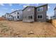 Home's backyard shows a small deck with a gray exterior; unfinished and ready for landscaping at 1290 Loraine N Cir, Lafayette, CO 80026