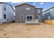 Home exterior showcasing a gray-colored exterior, small deck, and an unfinished backyard at 1290 Loraine N Cir, Lafayette, CO 80026