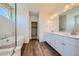Elegant bathroom with double vanities, a soaking tub, and a walk-in shower at 1290 Loraine N Cir, Lafayette, CO 80026