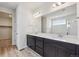 Bathroom features a double sink vanity with dark wood cabinets and modern lighting at 1290 Loraine N Cir, Lafayette, CO 80026