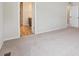 Spacious bedroom featuring neutral carpet, an ensuite bathroom, and closet doors at 1290 Loraine N Cir, Lafayette, CO 80026