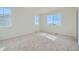 Spacious bedroom with neutral carpeting and large windows offering ample natural light at 1290 Loraine N Cir, Lafayette, CO 80026