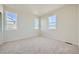 Bright bedroom with neutral carpeting and multiple windows at 1290 Loraine N Cir, Lafayette, CO 80026