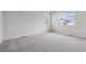 Bright bedroom with neutral carpet and two windows, allowing natural light at 1290 Loraine N Cir, Lafayette, CO 80026