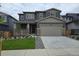 Charming two-story home featuring a two-car garage, welcoming porch, and well-maintained front yard and landscaping at 1290 Loraine N Cir, Lafayette, CO 80026