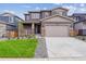 Charming two-story home featuring a well-manicured lawn, covered porch, and an attached two-car garage at 1290 Loraine N Cir, Lafayette, CO 80026