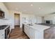 Modern kitchen featuring white cabinets, a large island, and stainless steel appliances at 1290 Loraine N Cir, Lafayette, CO 80026