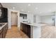 Bright kitchen boasts modern appliances, dark cabinetry, quartz countertops, a large island, and an open floor plan at 1290 Loraine N Cir, Lafayette, CO 80026