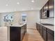 Modern kitchen featuring dark cabinets, quartz countertops, stainless steel appliances, and a large island at 1290 Loraine N Cir, Lafayette, CO 80026