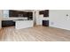 Spacious living room features a modern kitchen, wood flooring, and a bright, open layout at 1290 Loraine N Cir, Lafayette, CO 80026