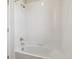 White tiled bathtub and shower featuring silver hardware and standard shower head at 1290 Loraine N Cir, Lafayette, CO 80026