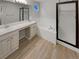 Well-lit bathroom featuring dual sinks, a soaking tub, and a glass-enclosed shower at 5236 S Liverpool Way, Centennial, CO 80015