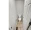 Compact powder room featuring tiled floor and a white toilet at 5236 S Liverpool Way, Centennial, CO 80015