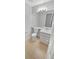 Bright bathroom with a white toilet, sink, and mirror at 5236 S Liverpool Way, Centennial, CO 80015