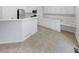 Bright kitchen features white cabinetry, modern appliances, and ample counter space at 5236 S Liverpool Way, Centennial, CO 80015
