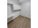 Functional laundry room featuring wood-look floors, white cabinets, and a convenient folding counter at 5236 S Liverpool Way, Centennial, CO 80015
