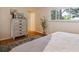 Bright bedroom features hardwood floors, a large window, and a stylish dresser with decorative accents at 4338 S Alton St, Greenwood Village, CO 80111