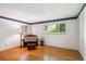 Empty bedroom with two large windows, hardwood flooring, decorative molding, and a built-in storage unit at 4338 S Alton St, Greenwood Village, CO 80111