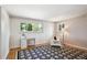 Cozy bedroom with a desk, large windows, hardwood floors, and a decorative rug and wallpaper at 4338 S Alton St, Greenwood Village, CO 80111