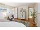 Charming bedroom boasts hardwood floors, decorative rug, stylish dresser, and an adjacent doorway at 4338 S Alton St, Greenwood Village, CO 80111
