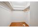 Spacious walk-in closet with hardwood floors, clothes rod, and ample storage space for an organized wardrobe at 4338 S Alton St, Greenwood Village, CO 80111